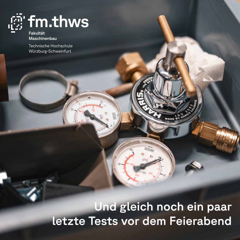 Dritte Karte: Foto eines Druckminderers mit zwei Manometern, oben die Wortmarke der Fakultät Maschinenbau, unten der Satz Und gleich noch ein paar letzte Tests vor dem Feierabend